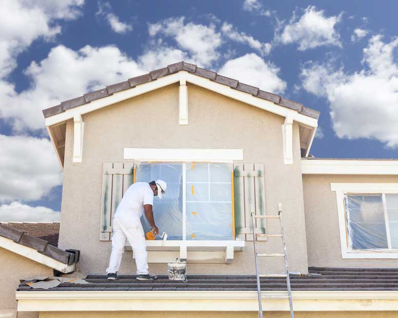 Façadier qui refait l'enduit d'une façade de maison